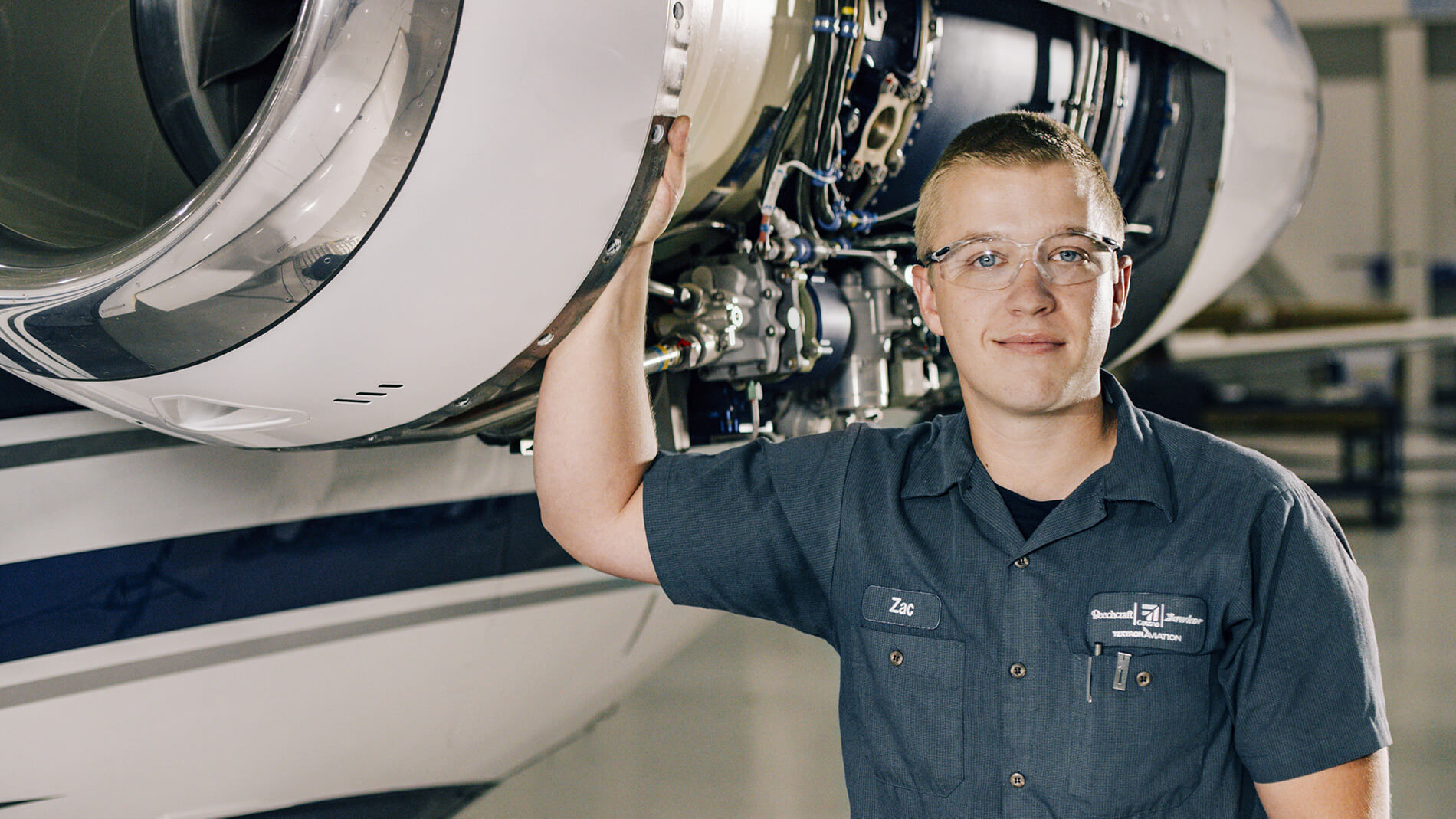 Technician maintaining jet engine 